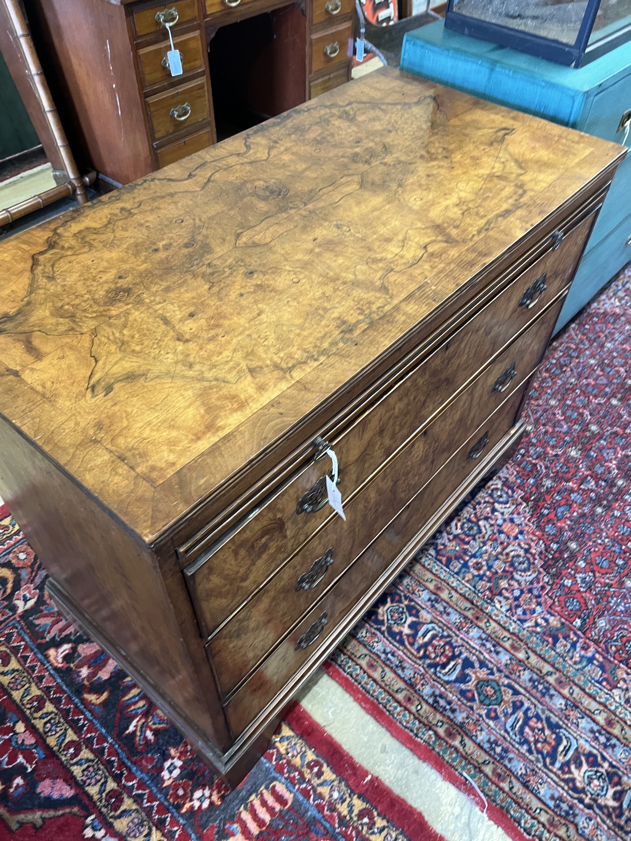 A Queen Anne Revival walnut three drawer chest with slide, width 108cm, depth 54cm, height 86cm